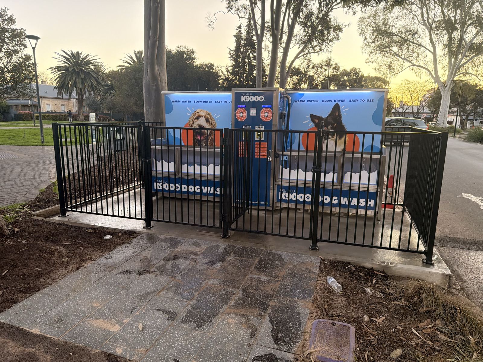 Fenced 24-hour dog wash station facing James Coke Park in Norwood, Adelaide, at dusk